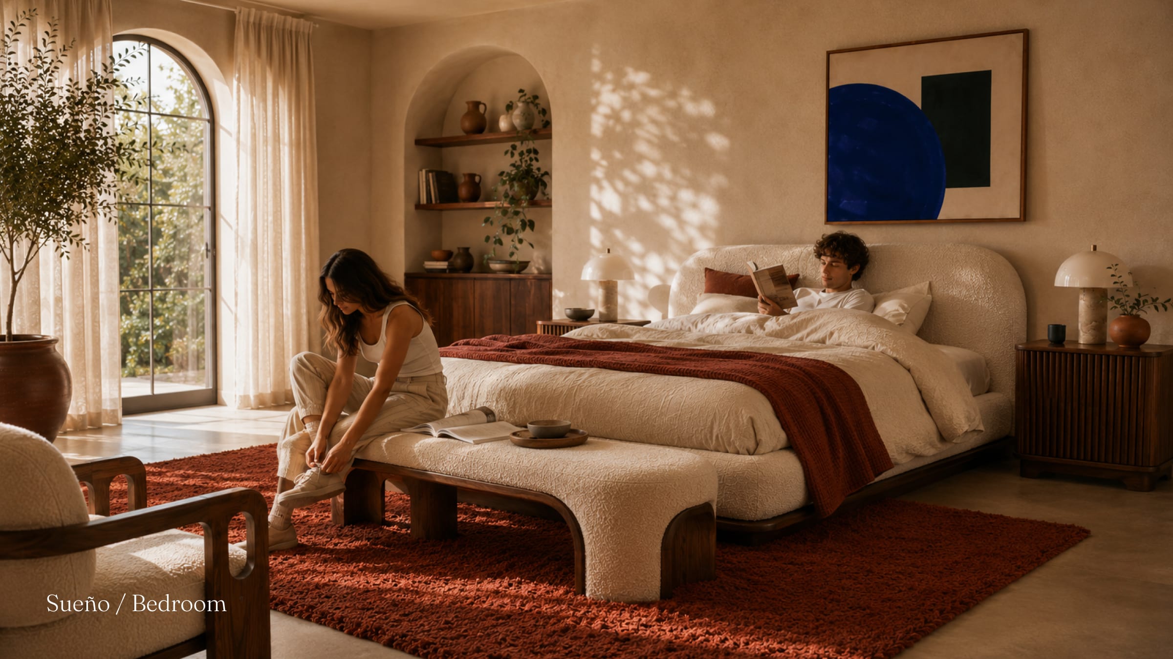 Brasa's Sueño bedroom, a bouclé bed on a deep terracotta rug in a plaster room.
