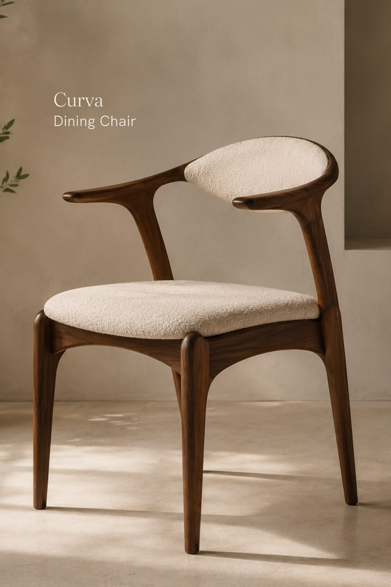 The Curva dining chair in walnut with a bouclé seat.