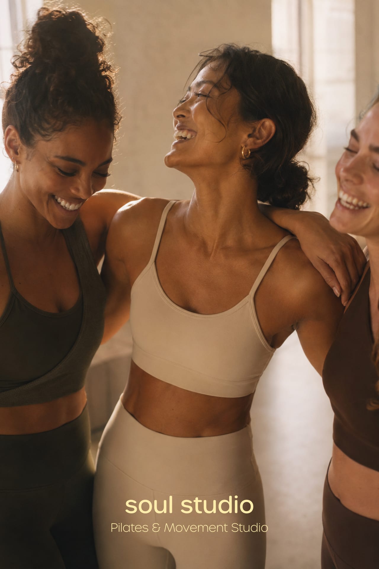 Three women embracing and smiling under the Soul Studio wordmark.