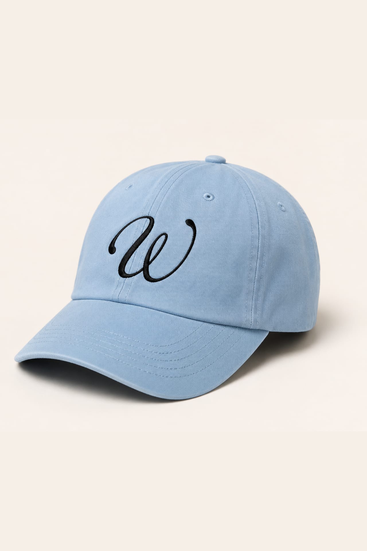 A powder-blue cap embroidered with the script W monogram.