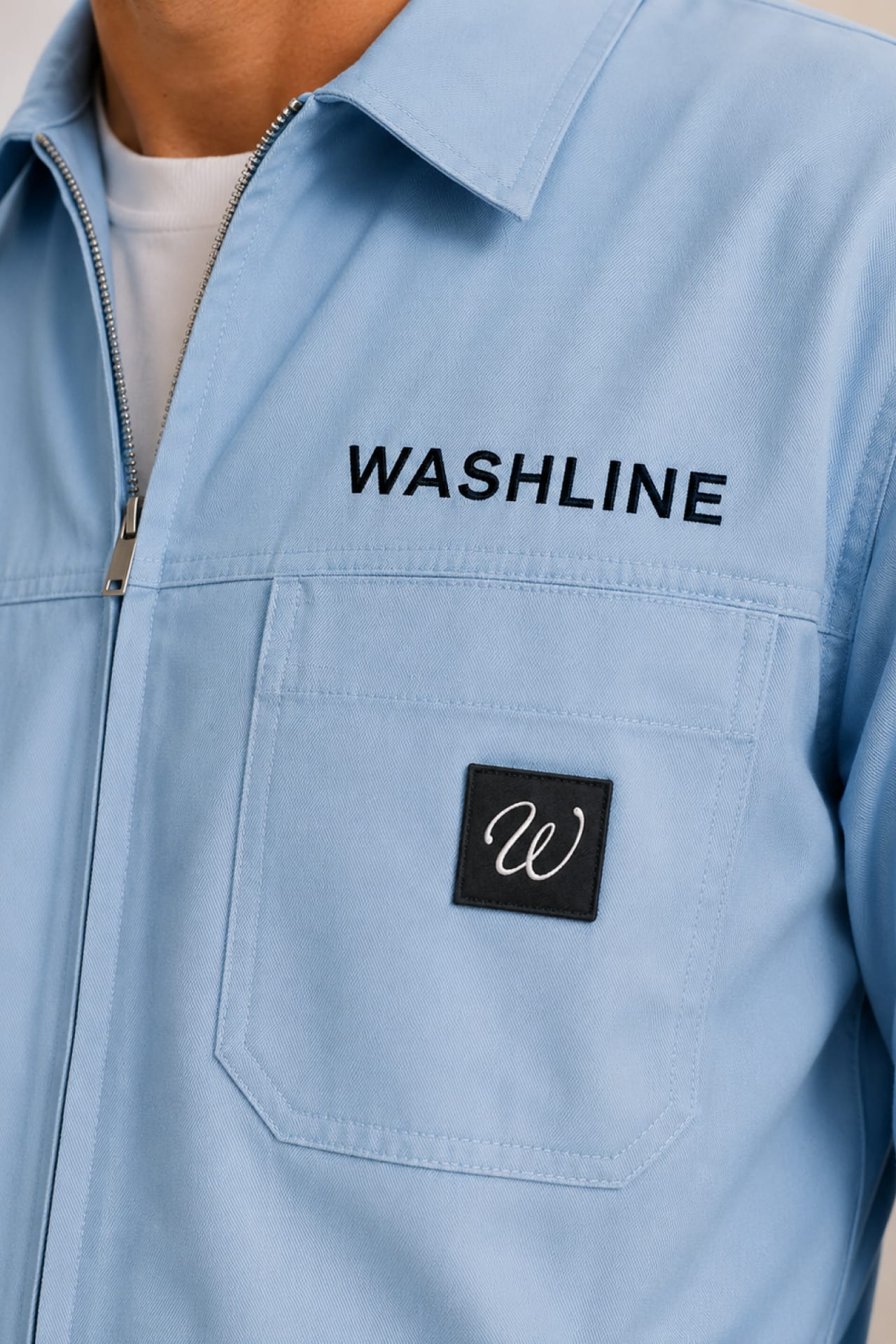 The boiler suit chest with woven monogram patch and Washline lettering.